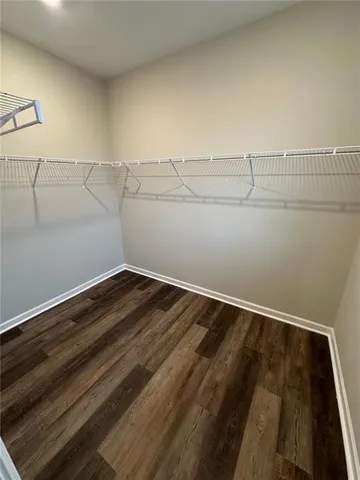 a view of a room with wooden floor
