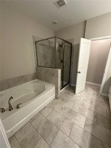 a bathroom with a tub and a shower
