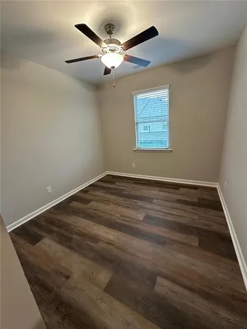 an empty room with wooden floor