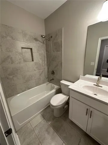 a bathroom with a toilet a sink and bathtub