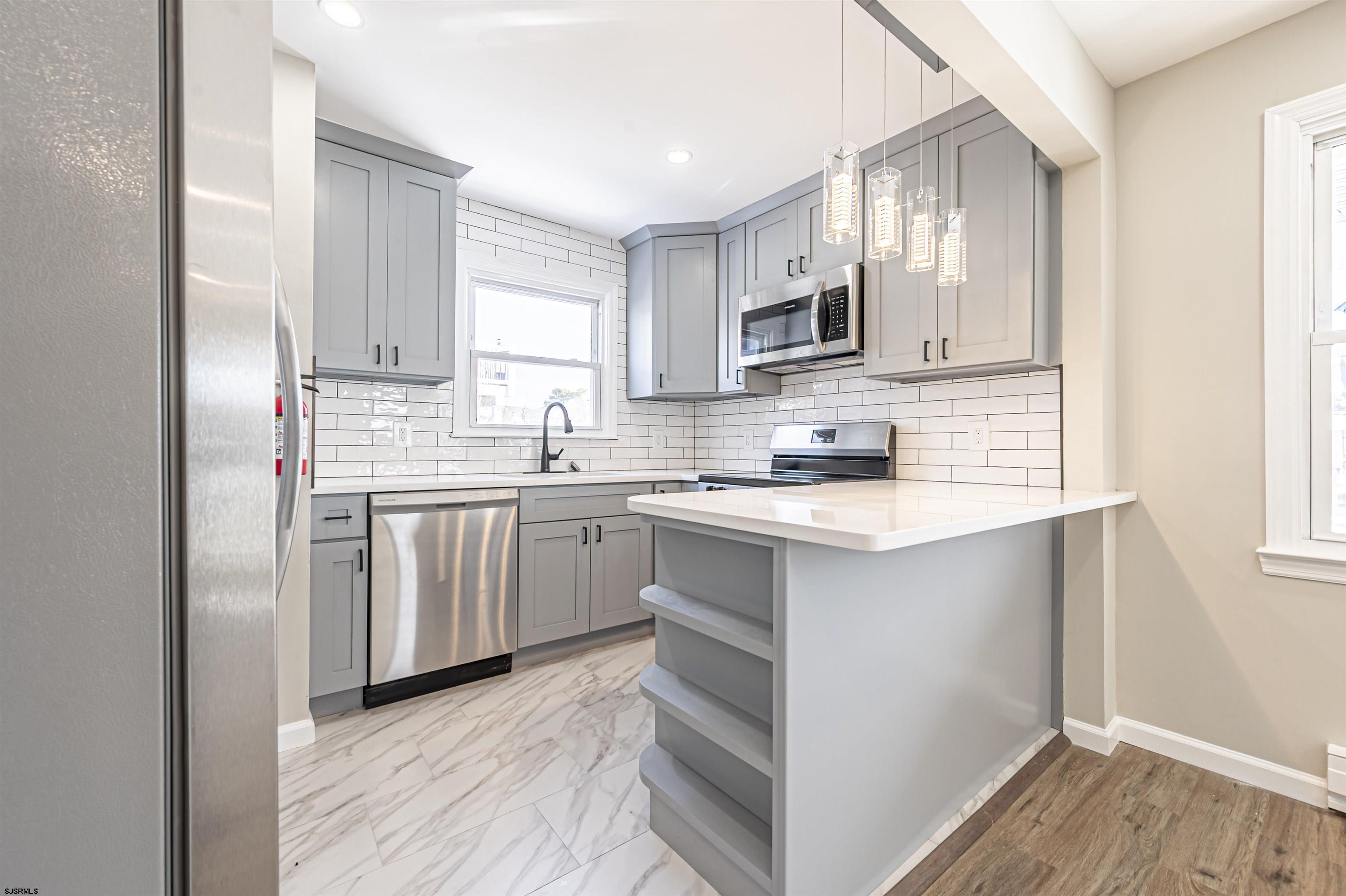 4617 Schooner Road, Unit A Brigantine, NJ 08203 - Photo 13 of 31 a kitchen with appliances cabinets and a sink