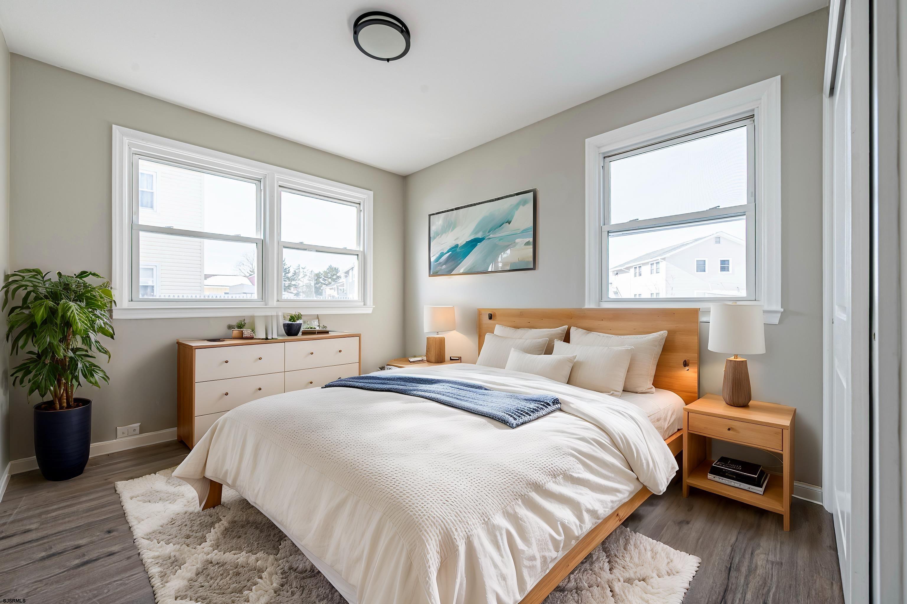4617 Schooner Road, Unit A Brigantine, NJ 08203 - Photo 18 of 31 a bedroom with a large bed and a potted plant