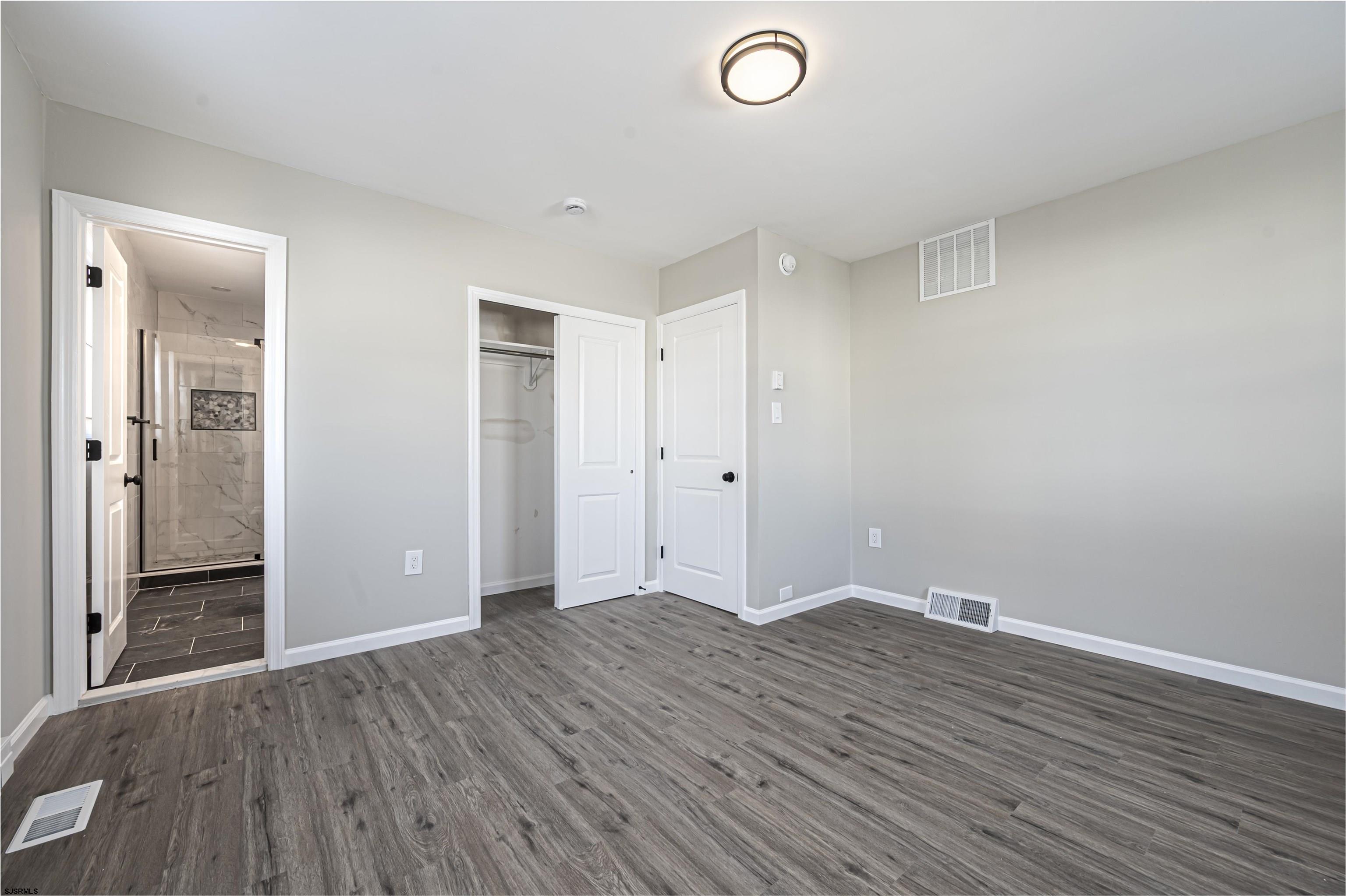 4617 Schooner Road, Unit A Brigantine, NJ 08203 - Photo 20 of 31 an empty room with wooden floor and mirror