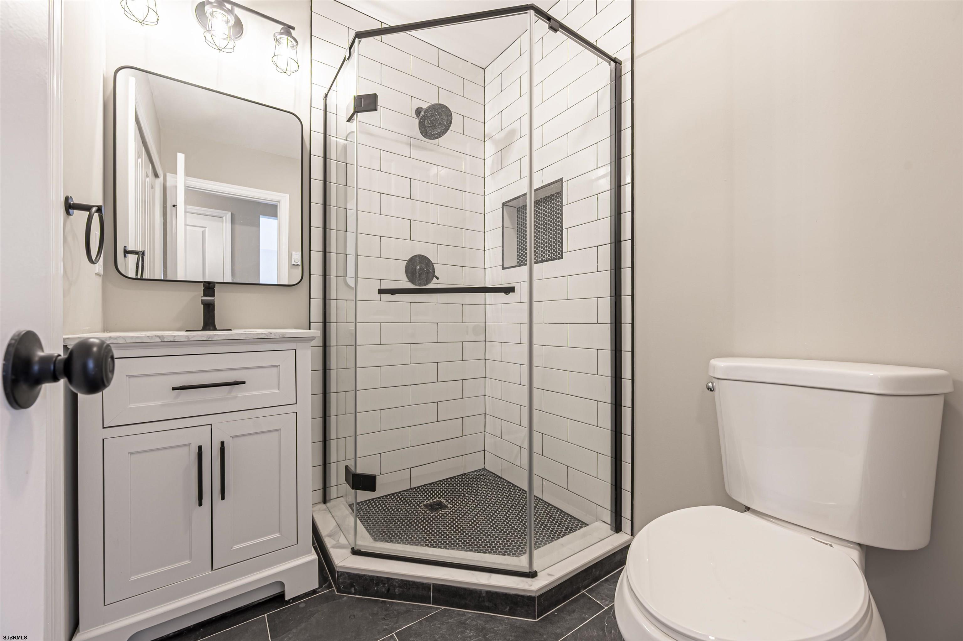 4617 Schooner Road, Unit A Brigantine, NJ 08203 - Photo 21 of 31 a bathroom with a sink a toilet and shower