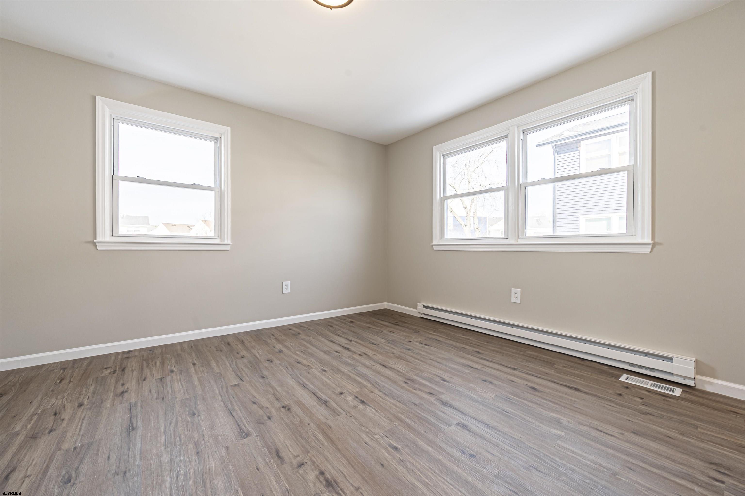 4617 Schooner Road, Unit A Brigantine, NJ 08203 - Photo 25 of 31 an empty room with wooden floor and windows