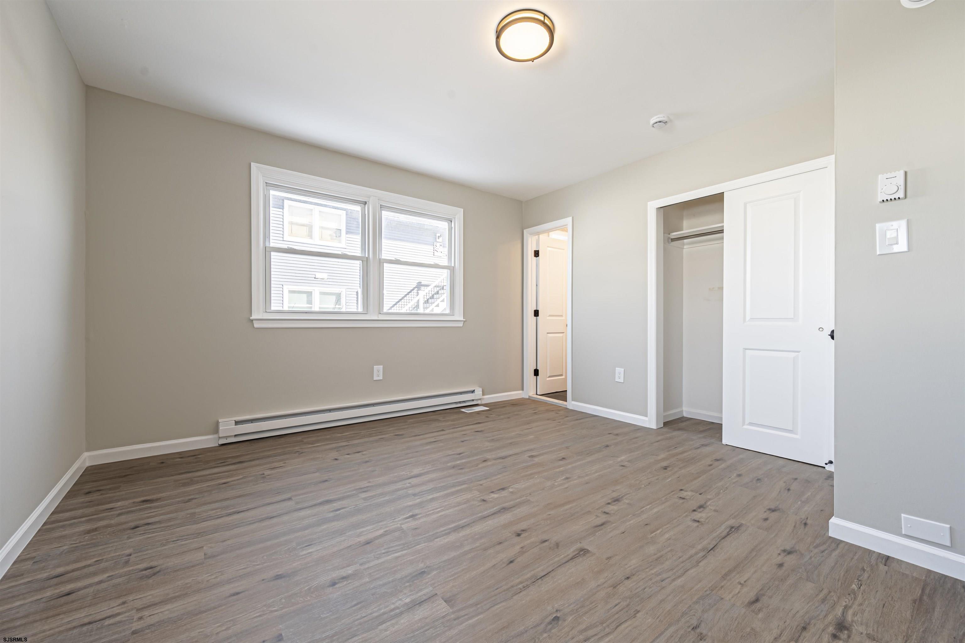 4617 Schooner Road, Unit A Brigantine, NJ 08203 - Photo 26 of 31 an empty room with wooden floor and windows