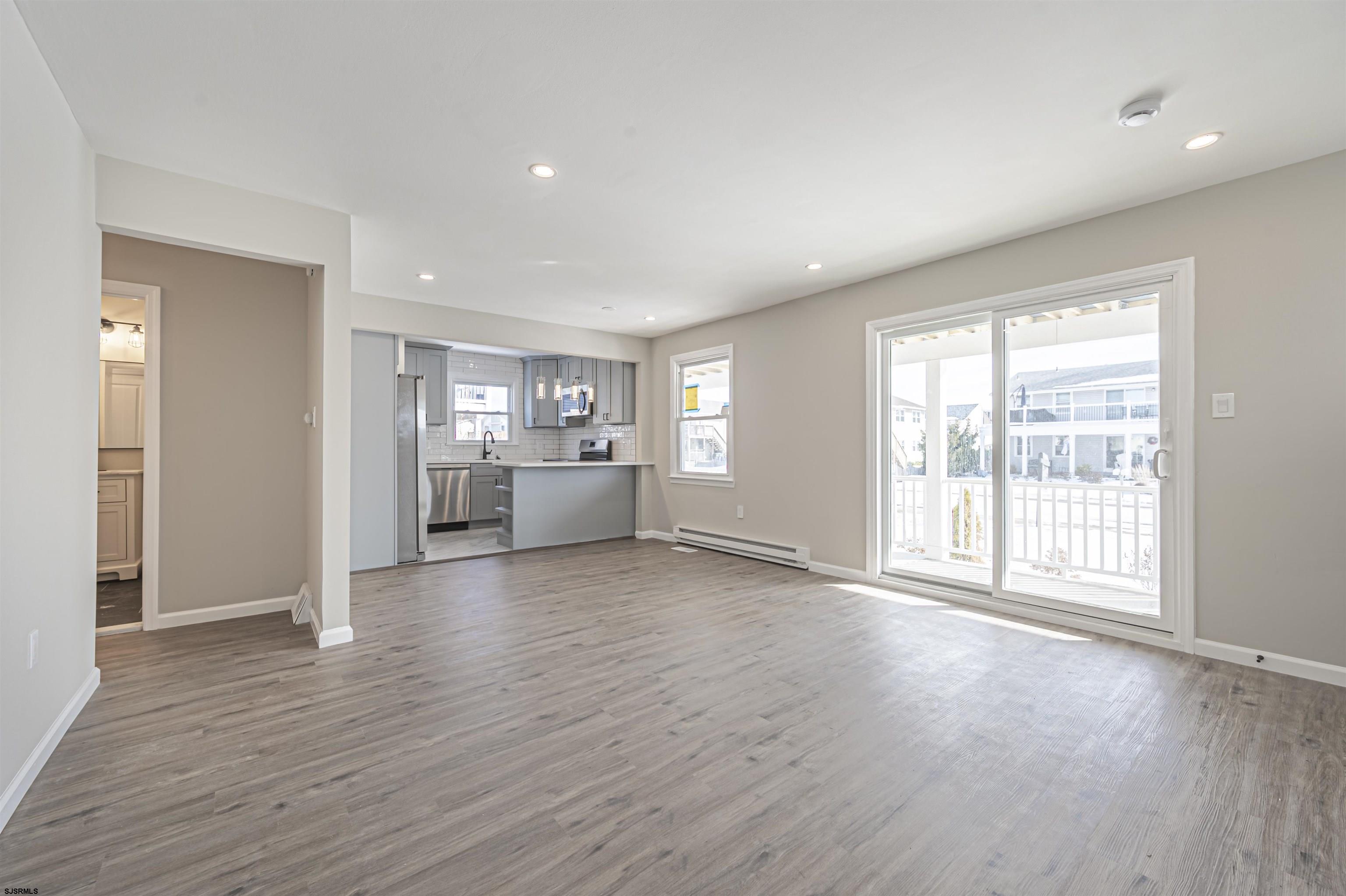 4617 Schooner Road, Unit A Brigantine, NJ 08203 - Photo 9 of 31 a view of an empty room with a window and wooden floor