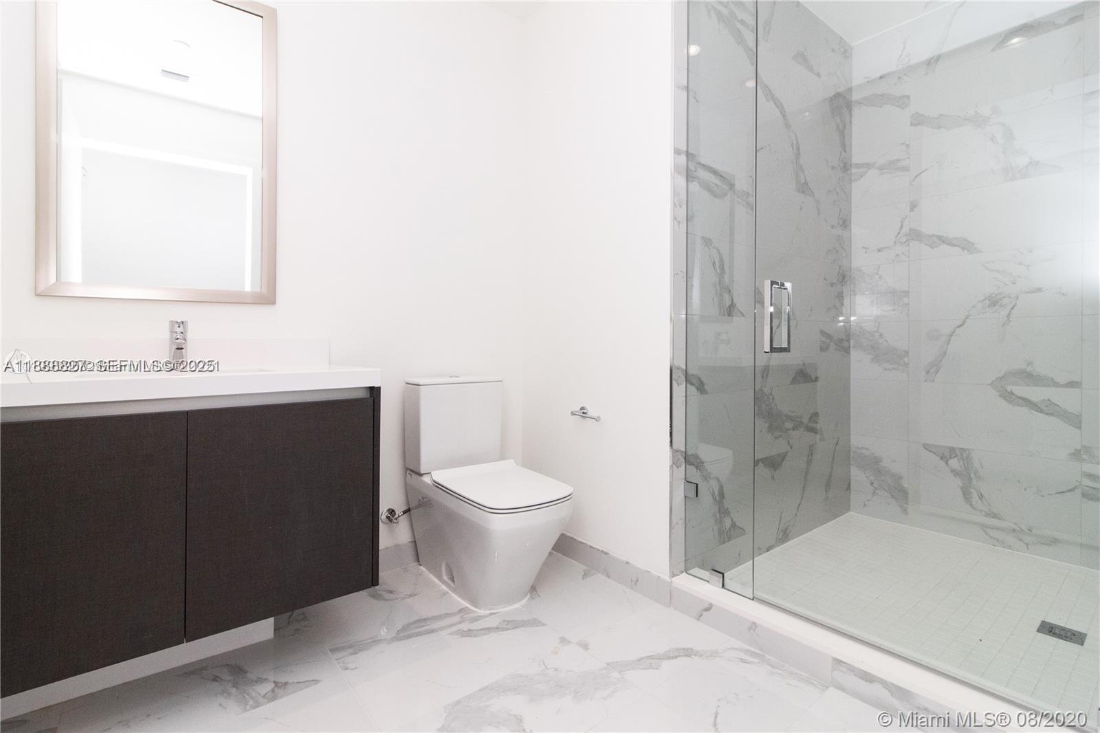 851 Northeast 1st Avenue, Unit 3601 Miami, FL 33132 - Photo 14 of 49 a bathroom with a sink and a mirror