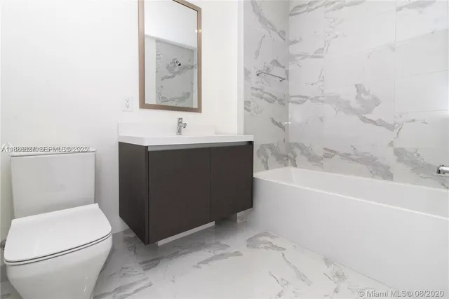 a bathroom with a sink a toilet and bathtub