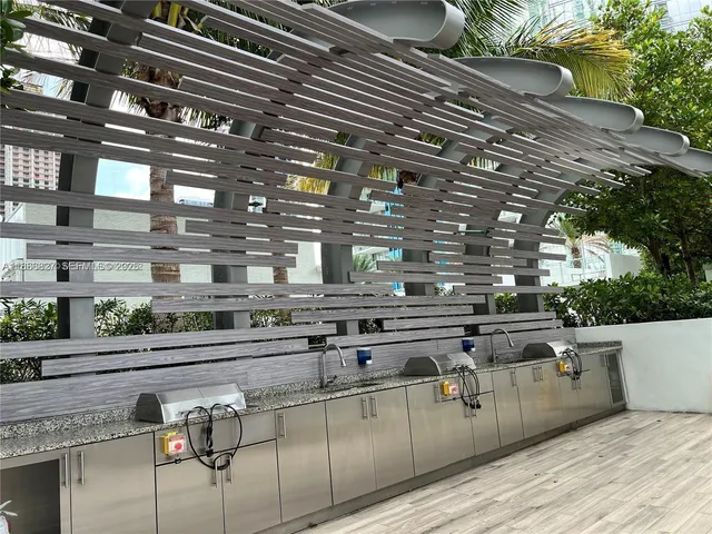 a open kitchen with stainless steel appliances wooden cabinets and stove top oven