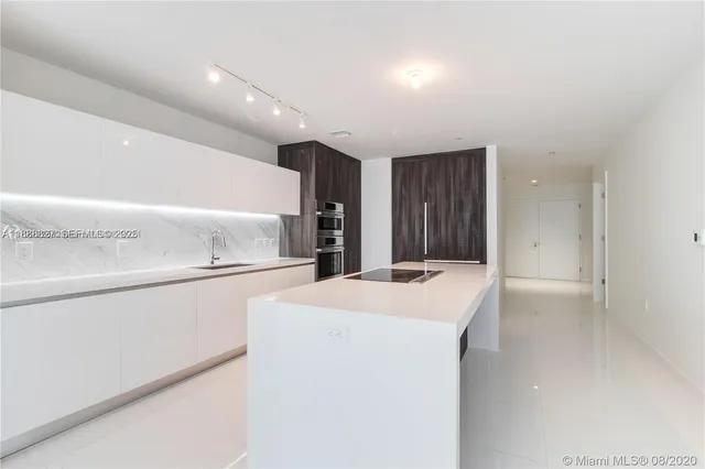 a kitchen with a sink and a refrigerator