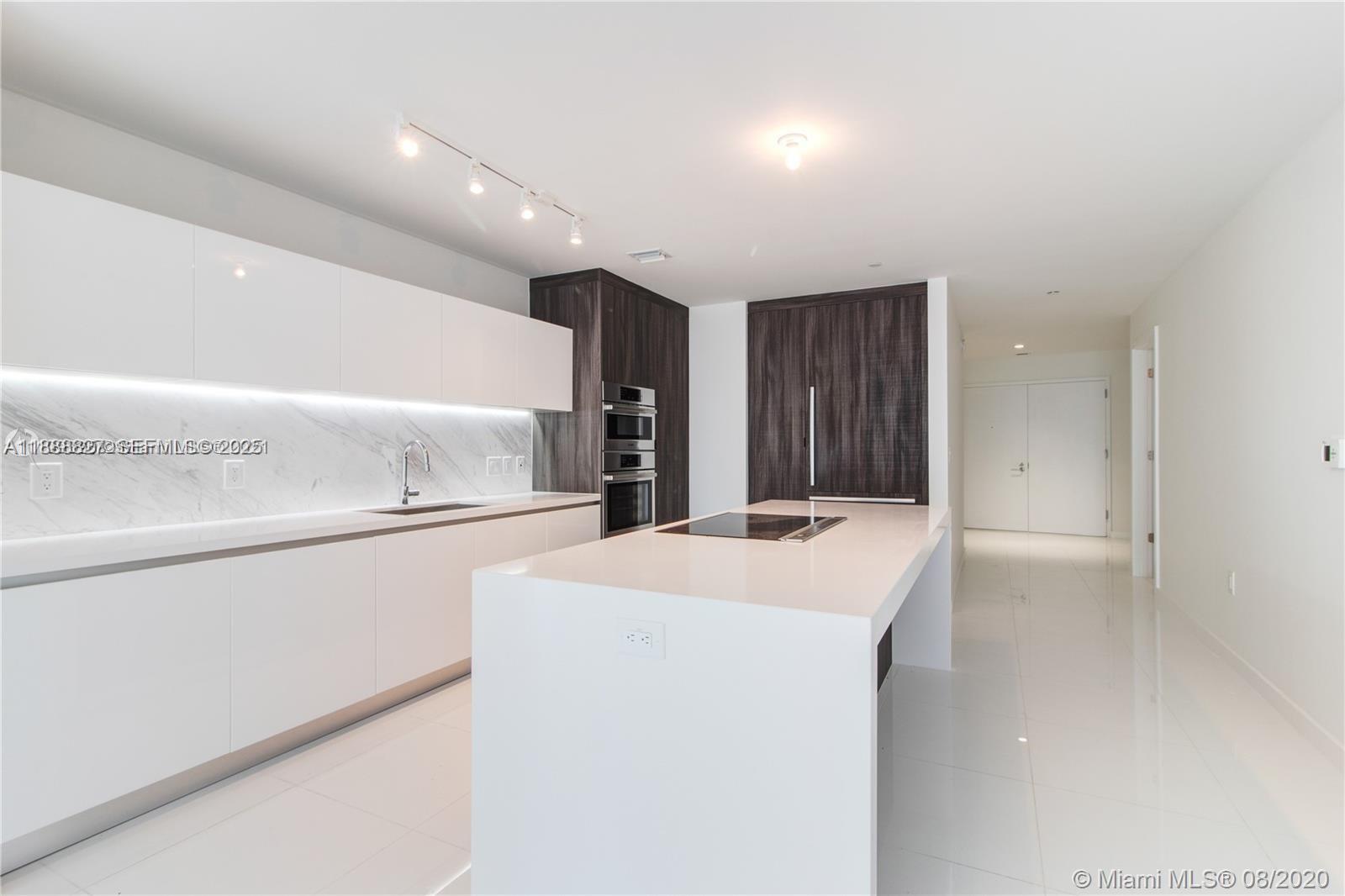 851 Northeast 1st Avenue, Unit 3601 Miami, FL 33132 - Photo 5 of 49 a kitchen with a sink and a refrigerator