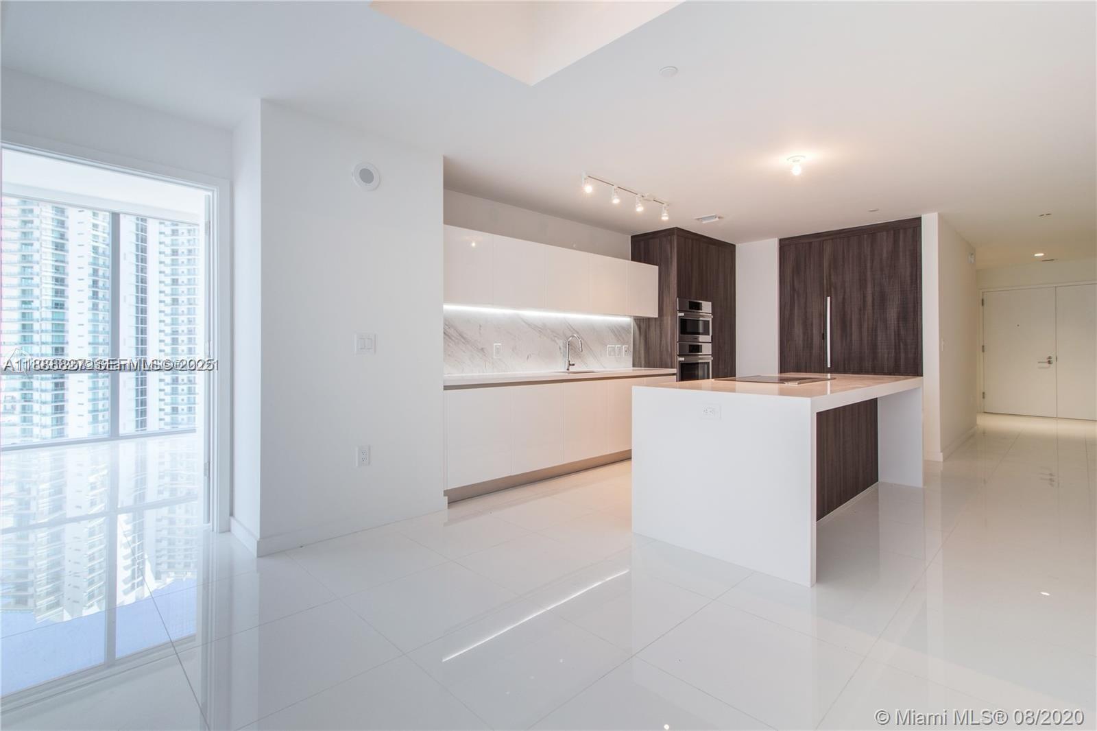 851 Northeast 1st Avenue, Unit 3601 Miami, FL 33132 - Photo 6 of 49 a kitchen with granite countertop a refrigerator and a sink