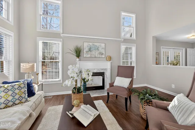 a kitchen with granite countertop a refrigerator a stove top oven a sink and dishwasher with wooden floor