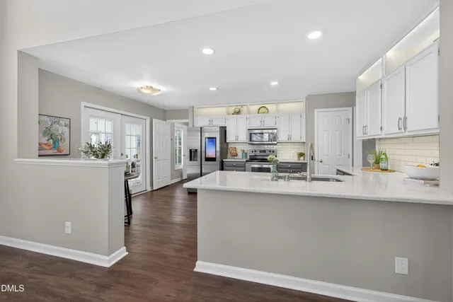 a kitchen with stainless steel appliances a stove a sink and a refrigerator