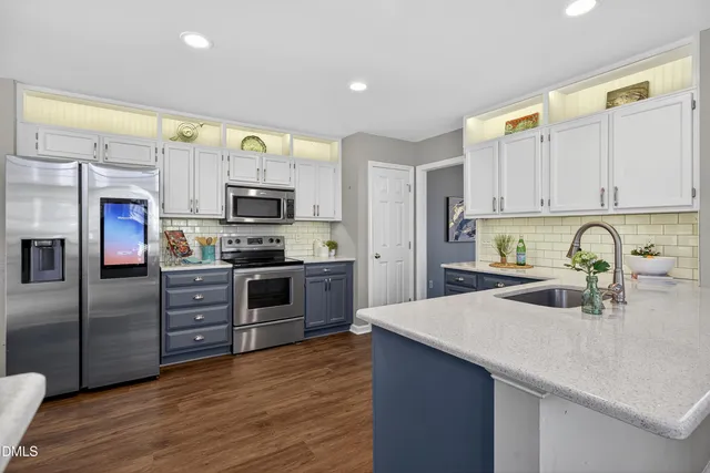 a kitchen with sink a stove and cabinets