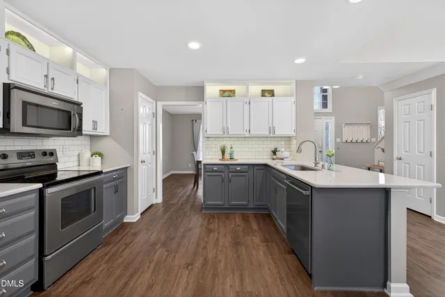 a kitchen with stainless steel appliances granite countertop a refrigerator and a sink
