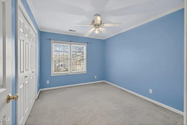 an aerial view of a house with a yard and lake view