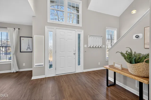 an empty room with wooden floor and a window