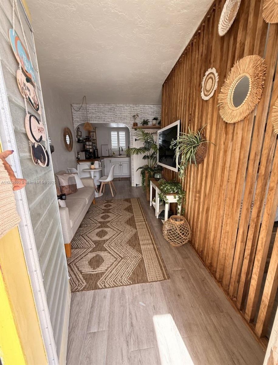 309 Crocus Terrace, Unit 9 Hollywood, FL 33019 - Photo 2 of 10 a living room with furniture and a wooden floor