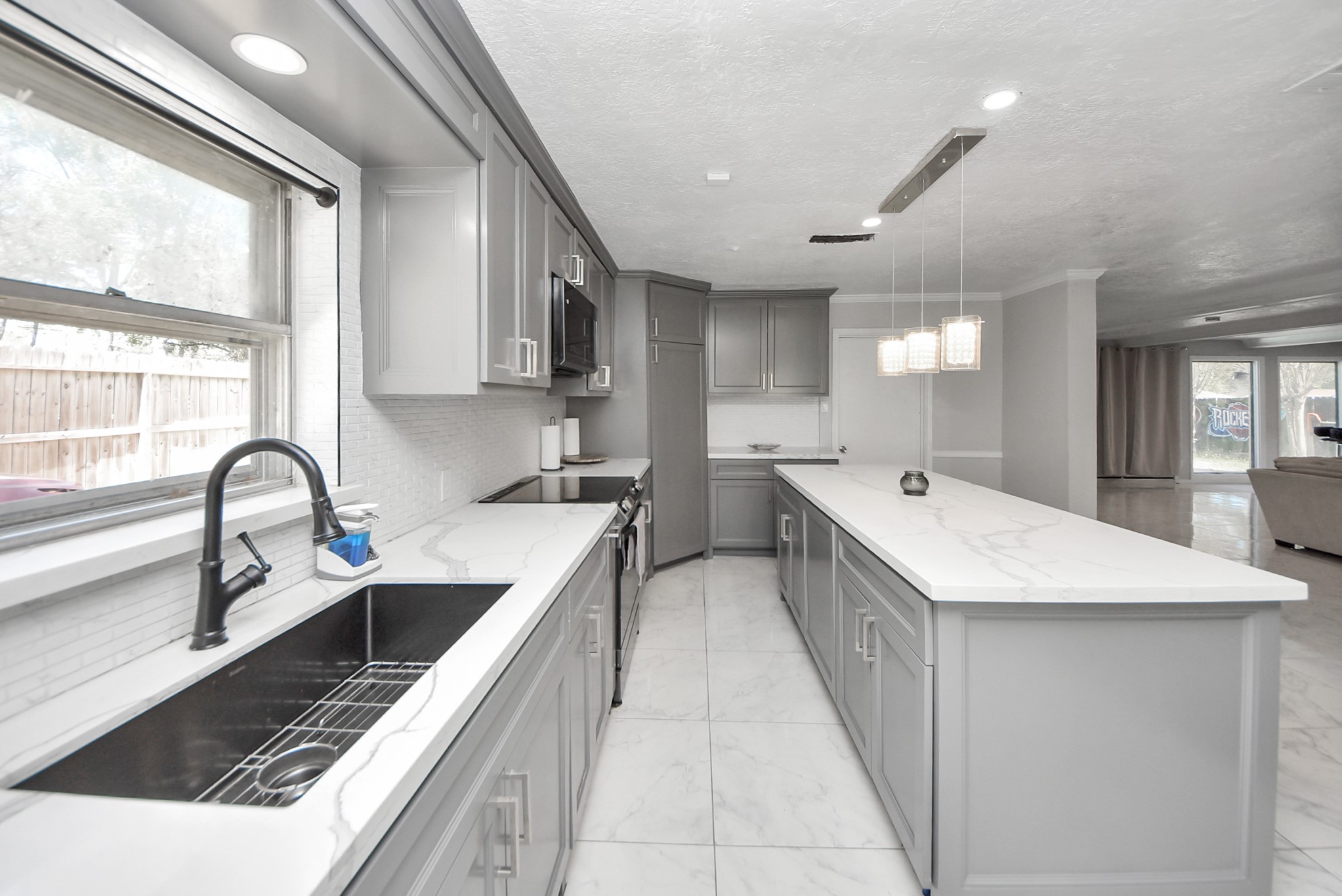 1011 Whitestone Lane Houston, TX 77073 - Photo 38 of 48 a large kitchen with stainless steel appliances kitchen island a large counter top a sink a stove a refrigerator and cabinets