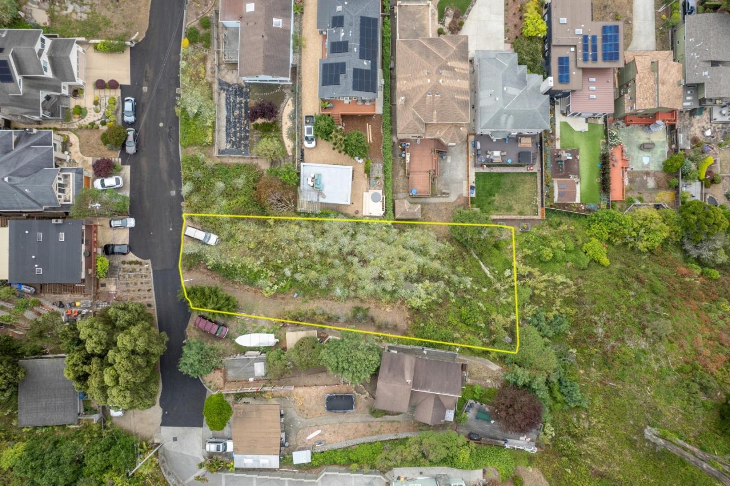 an aerial view of a residential apartment building with a yard
