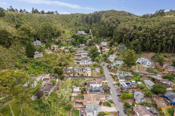 an aerial view of residential houses with outdoor space