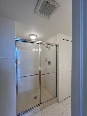 a bathroom with a glass shower door