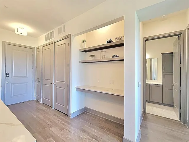 a view of a hallway with wooden floor