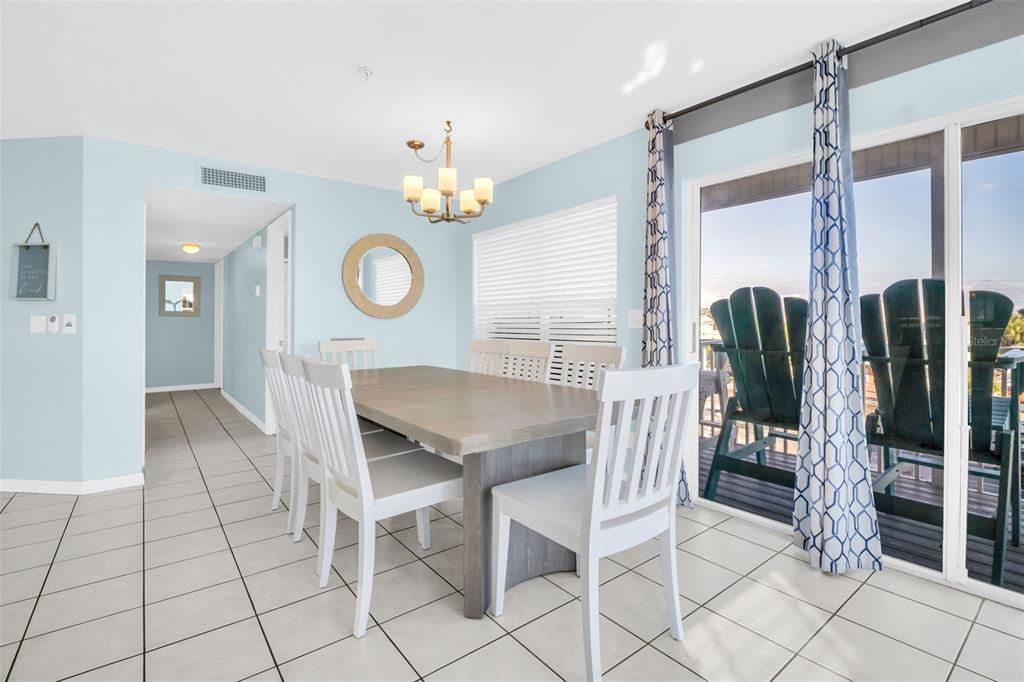 1802 Gulf Boulevard, Unit 12 Indian Rocks Beach, FL 33785 - Photo 11 of 41 a view of a dining room and kitchen with furniture wooden floor and window