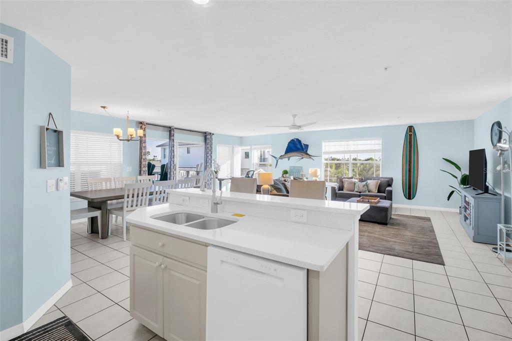 1802 Gulf Boulevard, Unit 12 Indian Rocks Beach, FL 33785 - Photo 17 of 41 a kitchen with sink cabinets and living room