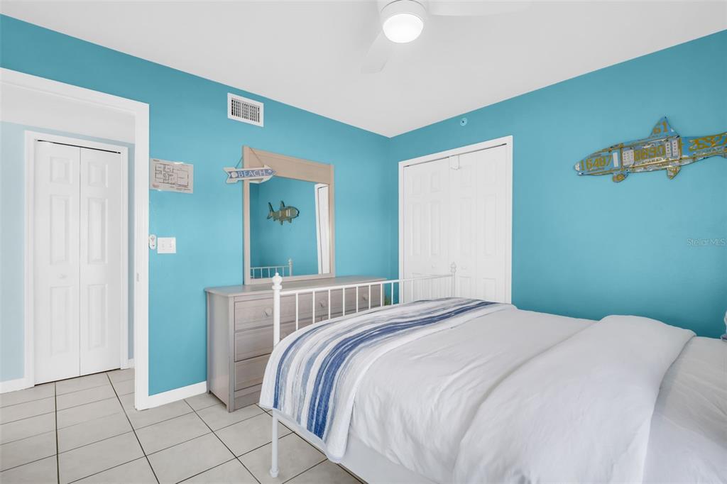 1802 Gulf Boulevard, Unit 12 Indian Rocks Beach, FL 33785 - Photo 18 of 41 a bedroom with a bed and mirror