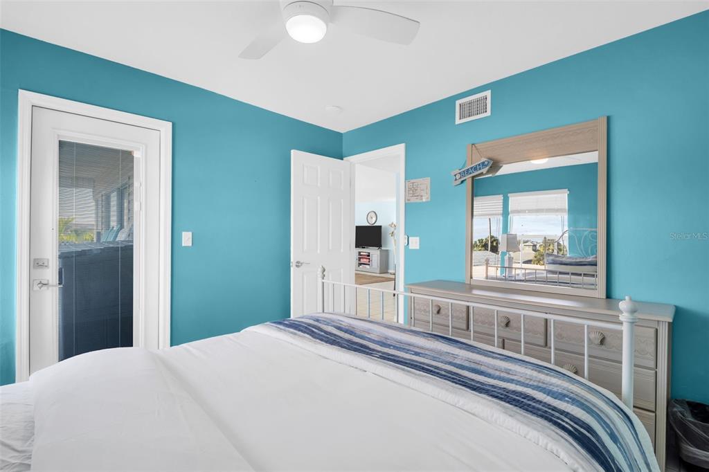 1802 Gulf Boulevard, Unit 12 Indian Rocks Beach, FL 33785 - Photo 20 of 41 a bedroom with a bed and a large mirror