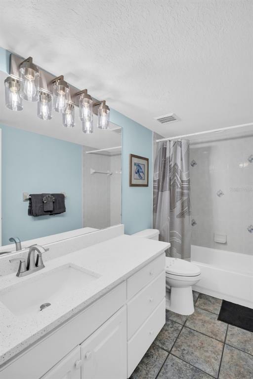 1802 Gulf Boulevard, Unit 12 Indian Rocks Beach, FL 33785 - Photo 22 of 41 a bathroom with a sink a toilet and a large mirror