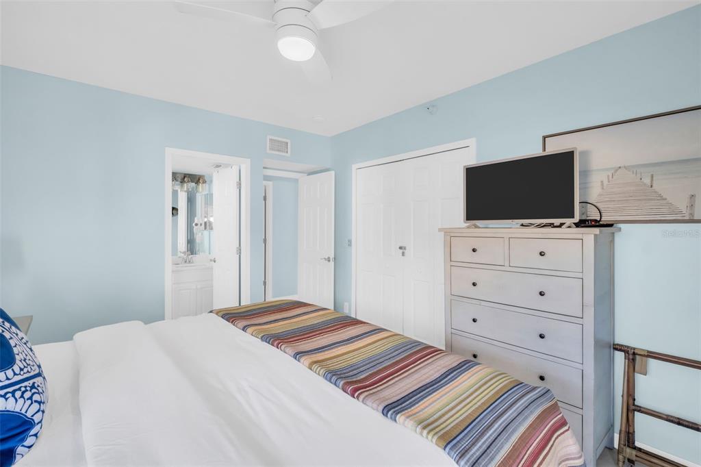 1802 Gulf Boulevard, Unit 12 Indian Rocks Beach, FL 33785 - Photo 27 of 41 a bedroom with a bed and a flat screen tv