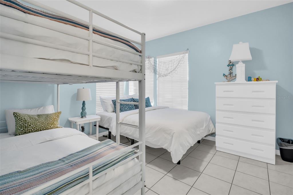 1802 Gulf Boulevard, Unit 12 Indian Rocks Beach, FL 33785 - Photo 29 of 41 a bedroom with a bed and a cabinets