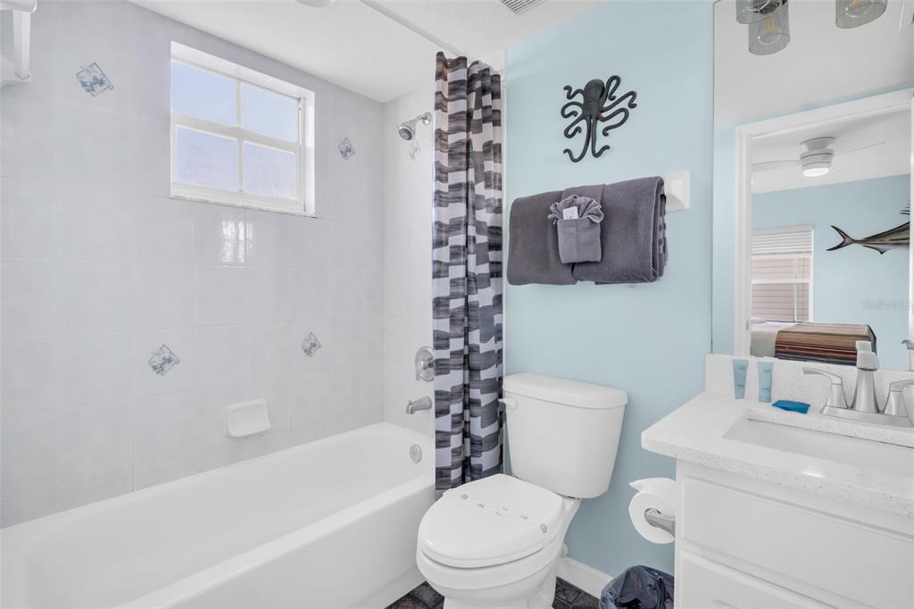 1802 Gulf Boulevard, Unit 12 Indian Rocks Beach, FL 33785 - Photo 30 of 41 a bathroom with a toilet sink and bathtub