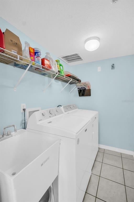 1802 Gulf Boulevard, Unit 12 Indian Rocks Beach, FL 33785 - Photo 31 of 41 a utility room with dryer and washer