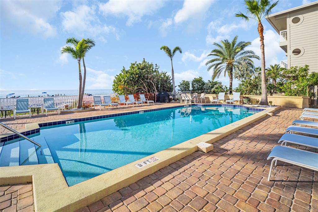 1802 Gulf Boulevard, Unit 12 Indian Rocks Beach, FL 33785 - Photo 34 of 41 a view of a swimming pool with a lounge chair