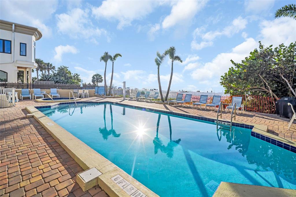 1802 Gulf Boulevard, Unit 12 Indian Rocks Beach, FL 33785 - Photo 35 of 41 a view of a swimming pool with outdoor seating