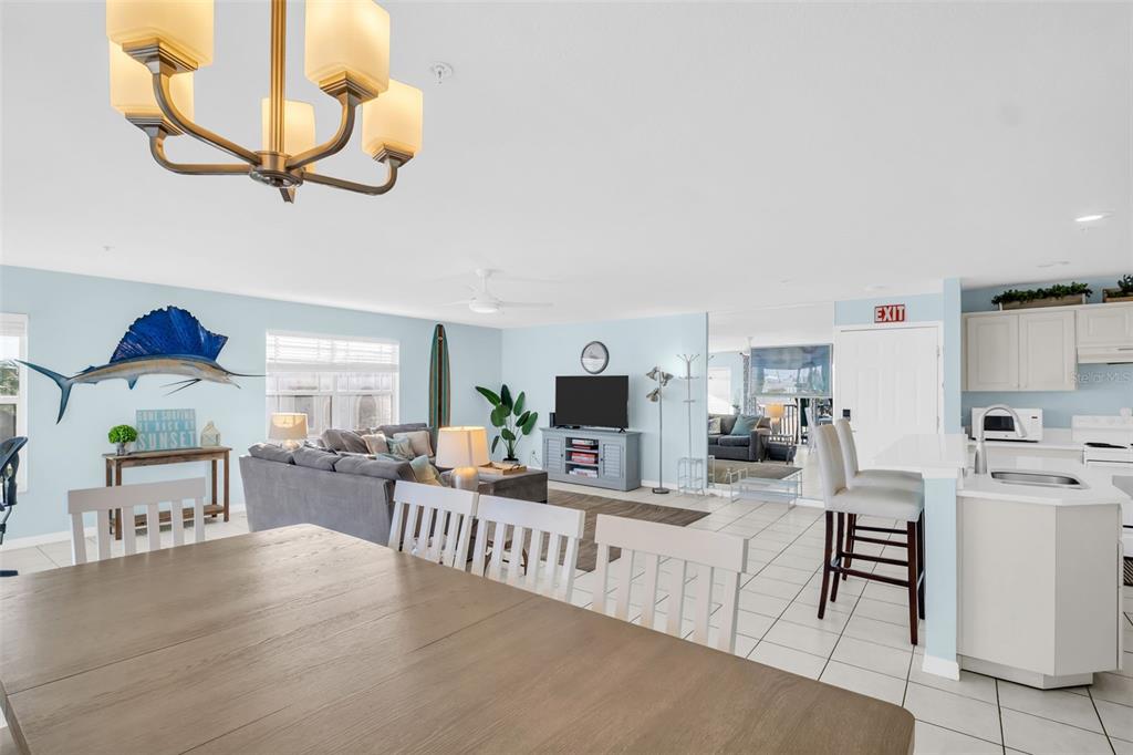 1802 Gulf Boulevard, Unit 12 Indian Rocks Beach, FL 33785 - Photo 7 of 41 a living room with furniture a flat screen tv and kitchen view