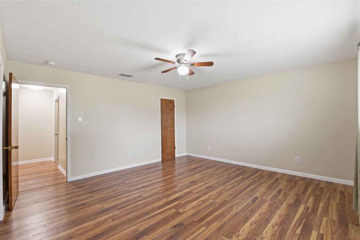 1250 Stockwell Damon, TX 77430 - Photo 32 of 50 an empty room with wooden floor and a ceiling fan