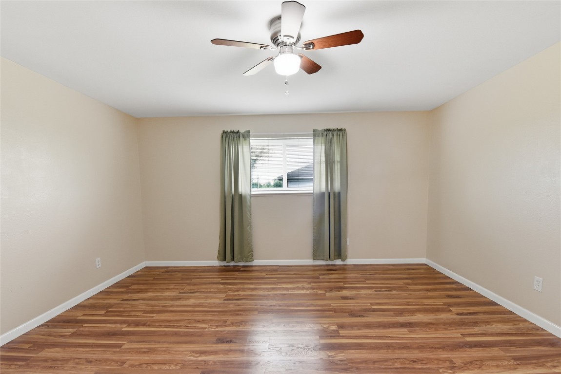 1250 Stockwell Damon, TX 77430 - Photo 34 of 50 a view of a room with wooden floor and a ceiling fan