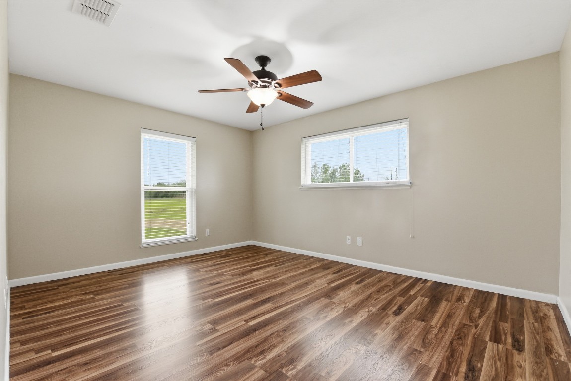 1250 Stockwell Damon, TX 77430 - Photo 38 of 50 a view of an empty room with wooden floor and a window