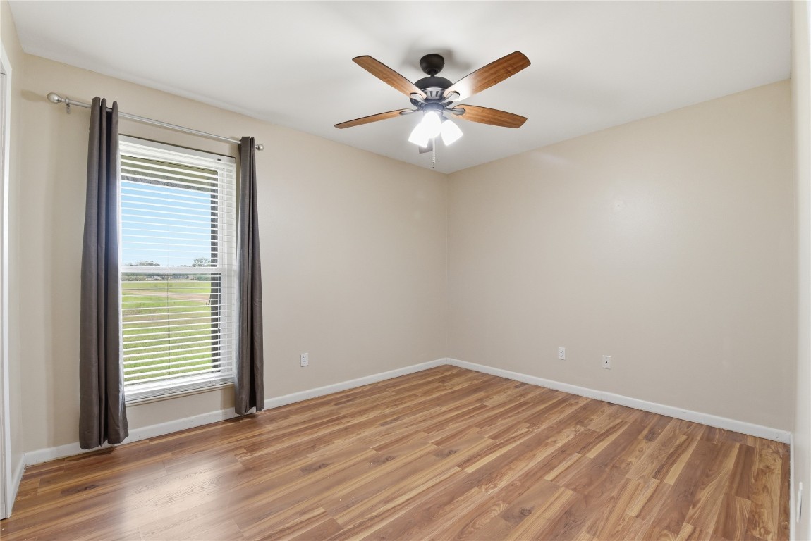 1250 Stockwell Damon, TX 77430 - Photo 41 of 50 an empty room with wooden floor fan and windows