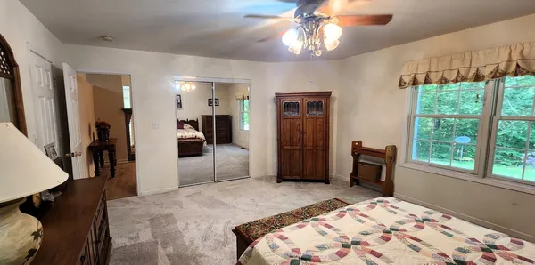 a bedroom with a bed and a chandelier