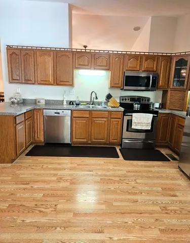 a view of a kitchen with kitchen island and wooden floor
