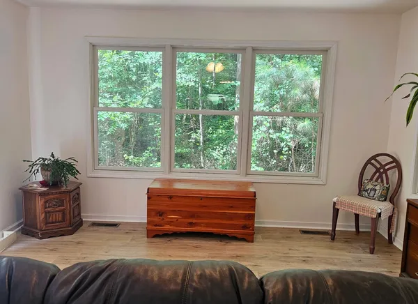 a living room with a bed furniture and a window