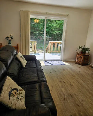 a living room with furniture and a floor to ceiling window