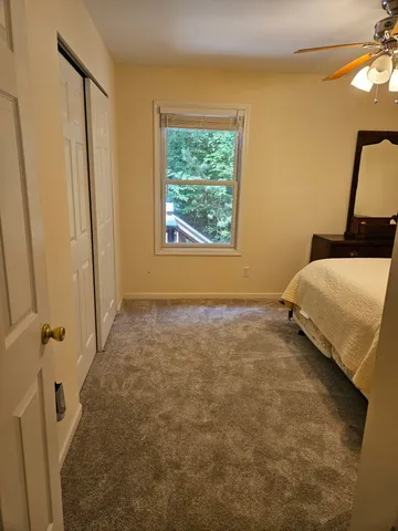 a bedroom with a bed and a window